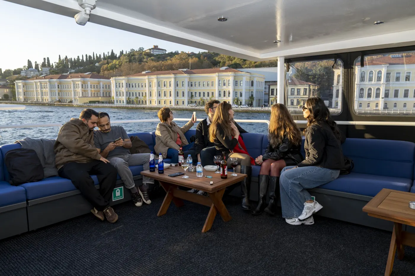 Guests in the yacht lounge in front of Dolmabahçe Palace